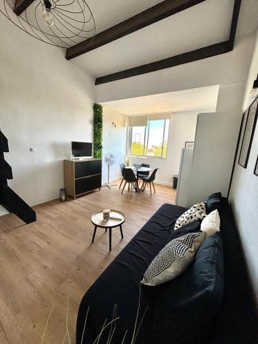 un salon avec un canapé et une table dans l'établissement Home, au Cap d'Agde