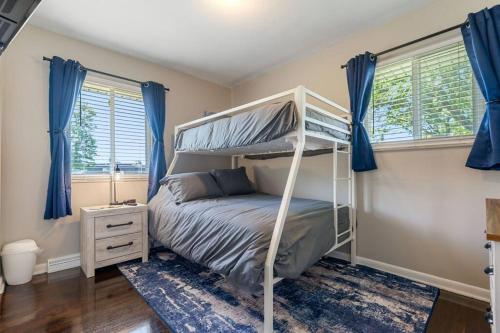 a bedroom with a bunk bed and blue curtains at Akron 2 Bed & 1 Bath Close to everything in Akron