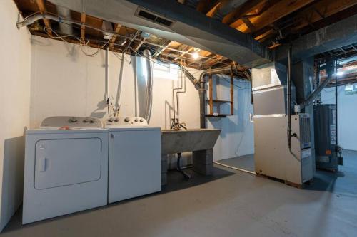 a laundry room with a sink and a tub at Akron 2 Bed & 1 Bath Close to everything in Akron