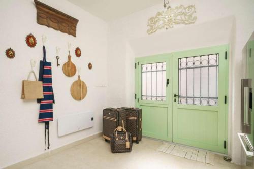 a room with a green door and some luggage at Seaside holiday house Zaton, Krka - 23406 in Zaton