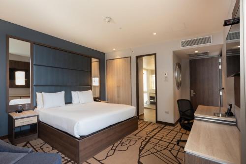 a hotel room with a bed and a desk at Hilton Garden Inn Bogota Airport in Bogotá
