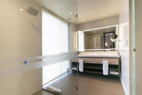 a bathroom with a sink and a mirror at Hilton Garden Inn Bogota Airport in Bogotá