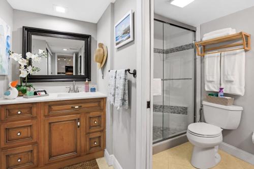 a bathroom with a shower and a toilet and a sink at Beachfront paradise Ocean Village Golf Tennis Several heated pools Tiki bar Pickleball insite sports bar and restaurant and much more in Fort Pierce