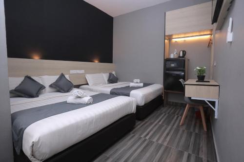 Ένα ή περισσότερα κρεβάτια σε δωμάτιο στο DJ Citi Inn Premier