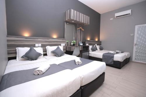 Ένα ή περισσότερα κρεβάτια σε δωμάτιο στο DJ Citi Inn Premier