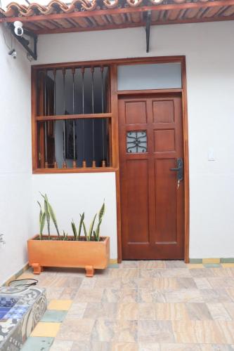 a red door of a house with plants in a pot at Hotel Ambar La Morada in Buga