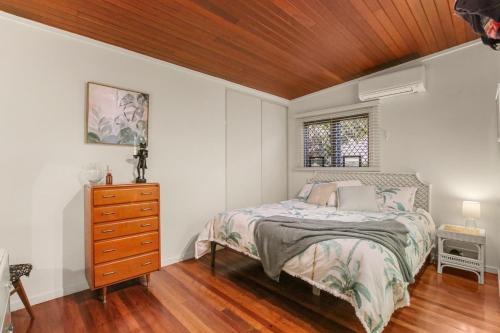 a bedroom with a bed and a wooden ceiling at Edmund Street 47, Shelly Beach in Caloundra