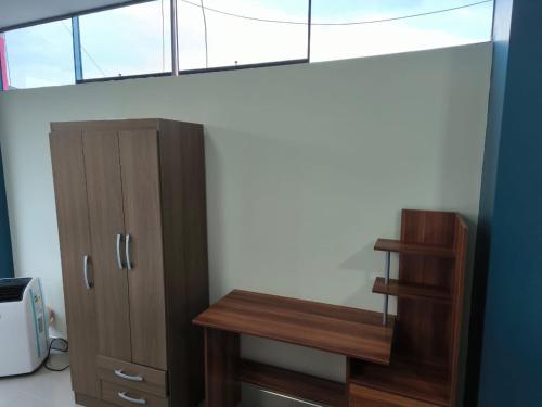 a room with a wooden cabinet and a window at HOTEL VIP 46 SSQS in Bagua Grande