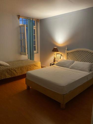 a bedroom with two beds and a window at Hostel Home in Mexico City
