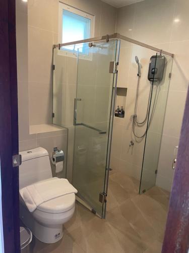 a bathroom with a toilet and a glass shower at DOI LUANG SCENE in Ban Tham