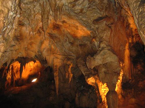 a cave with a person standing inside of it at Terzica avlija in Sevojno