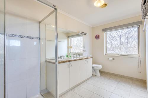 a bathroom with a shower and a sink and a toilet at StayAU Family Home Comfort in Caroline Springs in Caroline Springs