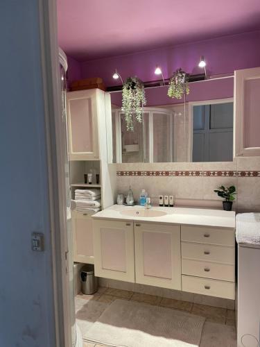 a kitchen with a sink and a purple ceiling at Séjourner dans un grand appartement 1 minute des transports et à seulement 8 minutes de Paris ! in Cachan