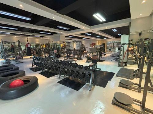 a gym with a bunch of equipment in a room at Lido De Paris Hotel in Manila