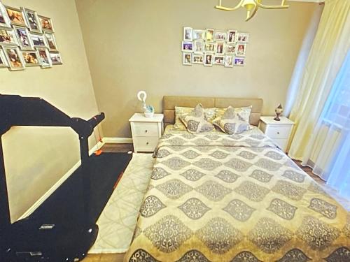a bedroom with a bed and some pictures on the wall at Luxury villa with sea view 1min to beach in Varna City