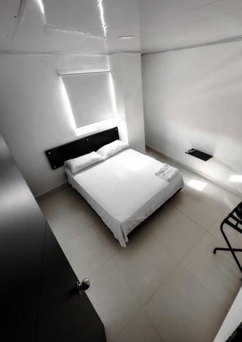 a bedroom with a white bed in a room at Hotel bazurto plaza in Cartagena de Indias