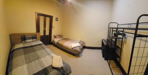 a room with two beds and a hallway with two bunk beds at Peaceful Haven in Adelaide