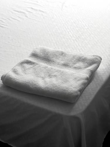 a towel is sitting on top of a bed at Hotel bazurto plaza in Cartagena de Indias
