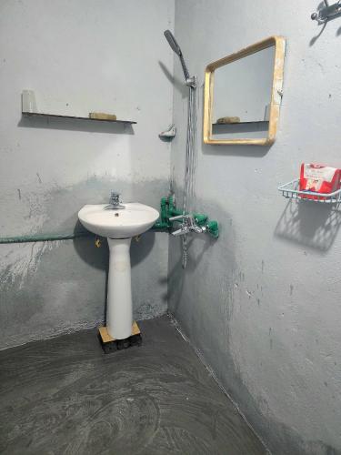 a bathroom with a sink and a mirror on a wall at TiTi House in Dồng Văn