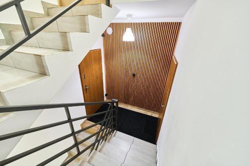 a staircase in a house with white walls and wood at Dworcowa 10D in Płock