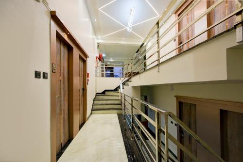 a long hallway with stairs in a building at The Pearl Plaza Hotel - Walking Distance From New Delhi Railway Station and Connaught Place in New Delhi