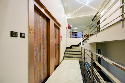 a hallway of a building with stairs and a door at The Pearl Plaza Hotel - Walking Distance From New Delhi Railway Station and Connaught Place in New Delhi