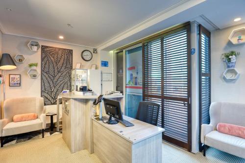 an office with a desk with a computer and two chairs at Marsden Viaduct in Auckland