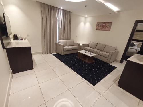 a living room with a couch and a table at Lamar Al Bawadi Hotel in Jeddah