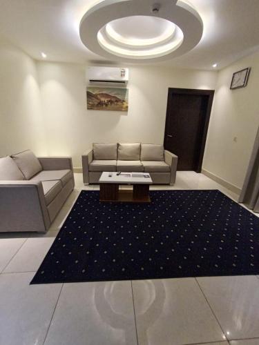 a living room with a couch and a table at Lamar Al Bawadi Hotel in Jeddah