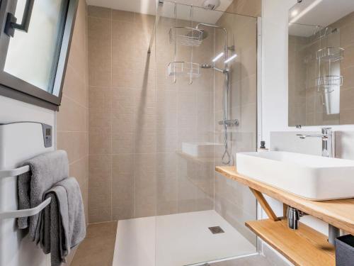 a bathroom with a sink and a shower at Ancien corps de ferme rénové avec jardin, terrasse et recharge EV, à 24 km de Nantes - FR-1-306-1282 in Saint-Colomban