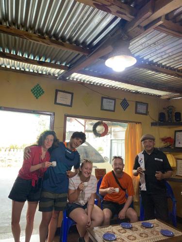a group of people posing for a picture in a room at Wisma PO'ONG in Ruteng