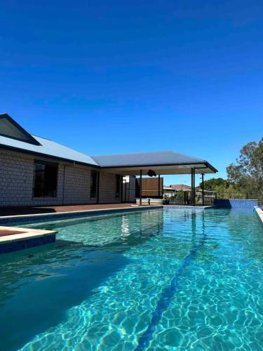 a large swimming pool with a gazebo at 7 Bedrooms 20 Mins to City 25 Acres of Green Space in Brisbane