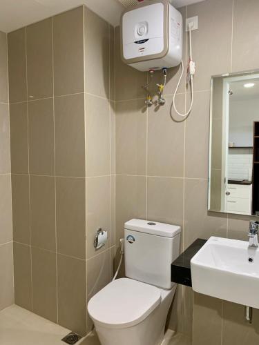 a bathroom with a toilet and a sink at Nuvasa Bay Studio Apartment 6A10 in Nongsa