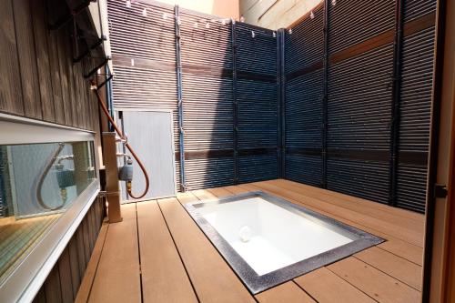 a bath tub in a room with a window at TokyoKoso Vacation Home in Tokyo