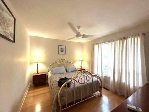a bedroom with a bed and a ceiling fan at Leslie in Wasaga Beach