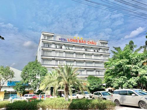 a large white building with a sign on it at Long Bao Chau Hotel in Thu Dau Mot