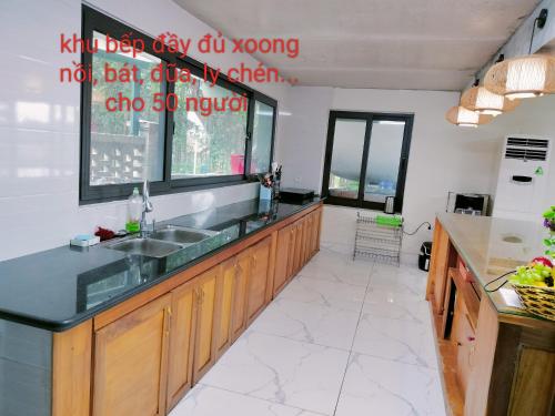a kitchen with a sink and a counter top at Nobita Villa Venuestay in Hanoi