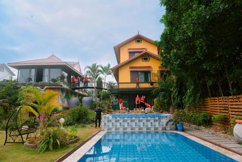 a house with a swimming pool in front of a house at Nobita Villa Venuestay in Hanoi