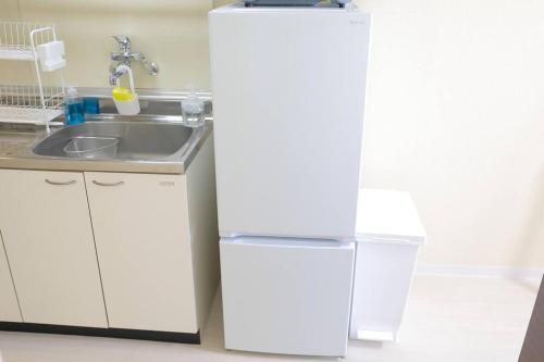 Η κουζίνα ή μικρή κουζίνα στο シティアヴェニュー旭町 すすきのエリア