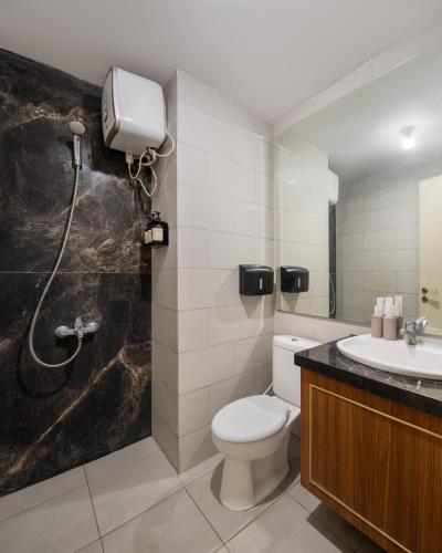 a bathroom with a toilet and a shower and a sink at RARE !!! - 2BR ANDERSON Highest Floor 37 - City View in Lontar