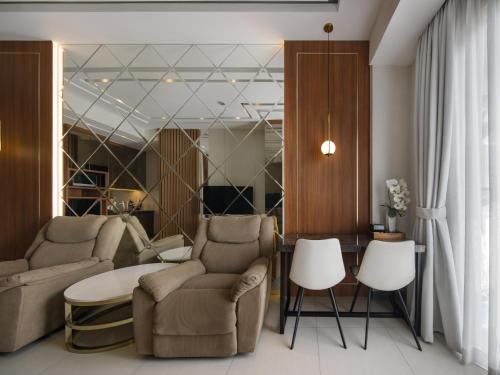 a living room with two chairs and a table at RARE !!! - 2BR ANDERSON Highest Floor 37 - City View in Lontar