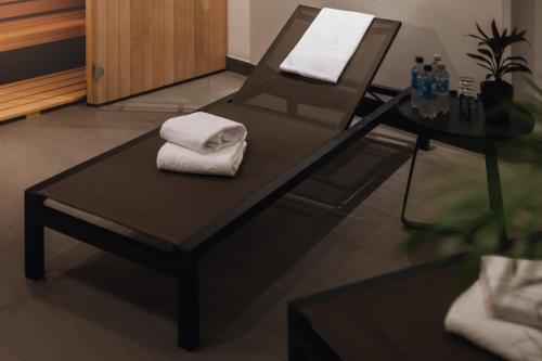 a chair and a table with towels on it at Holiday Inn - the niu, Belt Frankfurt Eschborn by IHG in Eschborn