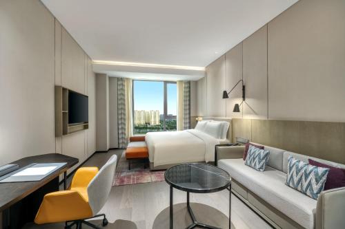 a hotel room with a couch and a bed at Crowne Plaza Lanzhou New Area by IHG in Lanzhou