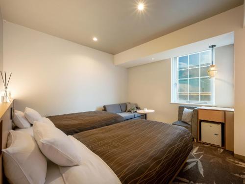 Ένα ή περισσότερα κρεβάτια σε δωμάτιο στο Sendai Washington Hotel