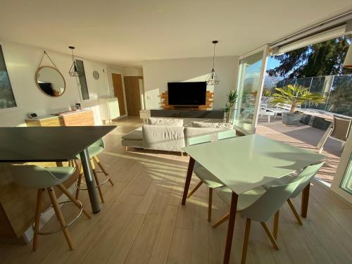 a living room with a glass table and chairs at Lausanne holidays in Renens