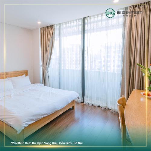 a bedroom with a bed and a large window at BIG Apartment Ha Noi in Hanoi