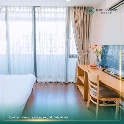 a bedroom with a desk with a computer and a bed at BIG Apartment Ha Noi in Hanoi