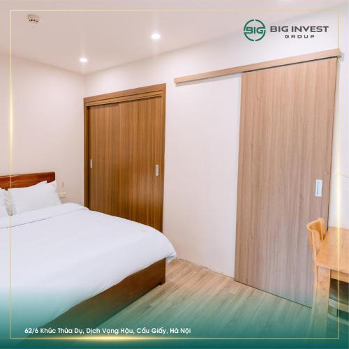 a bedroom with a bed and a sliding door at BIG Apartment Ha Noi in Hanoi