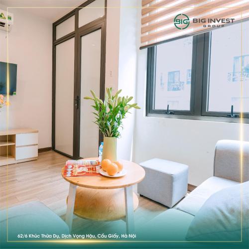 a living room with a table with a plant on it at BIG Apartment Ha Noi in Hanoi