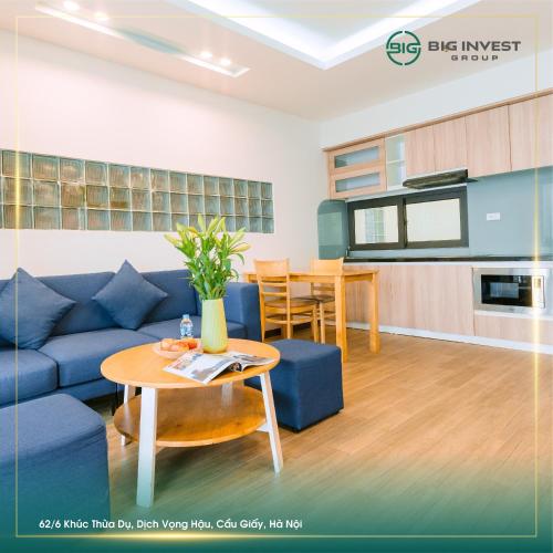 a living room with a blue couch and a table at BIG Apartment Ha Noi in Hanoi
